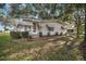 Landscaped yard with a white single-story home at 25143 Barrow Hl, Leesburg, FL 34748