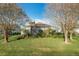 House's backyard with a screened enclosure and well-maintained lawn at 25220 Waterbridge Ct, Leesburg, FL 34748