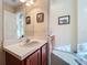 Guest bathroom with vanity, single sink, and wood cabinets at 25220 Waterbridge Ct, Leesburg, FL 34748