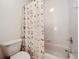 Clean bathroom with a shower/tub, toilet, and floral shower curtain at 25220 Waterbridge Ct, Leesburg, FL 34748