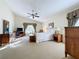 Spacious main bedroom with carpeted floor, large windows, and ceiling fan at 25220 Waterbridge Ct, Leesburg, FL 34748