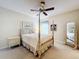 Bedroom with a post bed, ceiling fan, and a full-length mirror at 25220 Waterbridge Ct, Leesburg, FL 34748