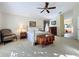 Bright bedroom with double bed, dresser, and ensuite access at 25220 Waterbridge Ct, Leesburg, FL 34748