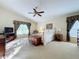 Bright and airy main bedroom with a ceiling fan and large windows at 25220 Waterbridge Ct, Leesburg, FL 34748