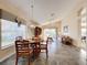 Open dining area with a round table and chairs, adjacent to the kitchen and living room at 25220 Waterbridge Ct, Leesburg, FL 34748