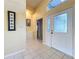 Bright entryway with tiled floors and a view to the living room at 25220 Waterbridge Ct, Leesburg, FL 34748