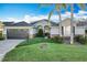 One-story house with a dark brown garage door and well-manicured lawn at 25220 Waterbridge Ct, Leesburg, FL 34748