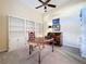 Home office with built-in shelving, desk, and ceiling fan at 25220 Waterbridge Ct, Leesburg, FL 34748