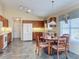 Bright kitchen with oak cabinets, white appliances, and tiled floor at 25220 Waterbridge Ct, Leesburg, FL 34748