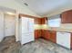 Kitchen features oak cabinets, white appliances, and tiled floor at 25220 Waterbridge Ct, Leesburg, FL 34748