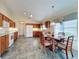 Bright kitchen with oak cabinets, white appliances, and tiled floor at 25220 Waterbridge Ct, Leesburg, FL 34748