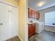 Laundry room with washer, dryer, cabinets, and access to exterior at 25220 Waterbridge Ct, Leesburg, FL 34748