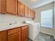 Laundry room with washer, dryer, cabinets, and sink at 25220 Waterbridge Ct, Leesburg, FL 34748