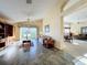 Spacious living room with tiled floors and a view into the adjacent dining area at 25220 Waterbridge Ct, Leesburg, FL 34748