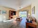 Living room with tiled floors, a sofa, and a view of the backyard at 25220 Waterbridge Ct, Leesburg, FL 34748