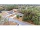 Aerial view of a single-Gathering home on a tree-lined street in a residential neighborhood at 26 Pecan Pass Run, Ocala, FL 34472