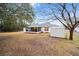 Backyard view of home with shed and large grassy area at 26 Pecan Pass Run, Ocala, FL 34472