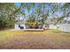 View of the home from the backyard, showing the patio and shed at 26 Pecan Pass Run, Ocala, FL 34472