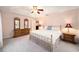 Spacious bedroom with a large bed, dresser, and two nightstands at 26 Pecan Pass Run, Ocala, FL 34472