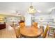 Bright dining room with wood table and view to living room at 26 Pecan Pass Run, Ocala, FL 34472