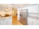 Kitchen with stainless steel refrigerator and white cabinets at 26 Pecan Pass Run, Ocala, FL 34472