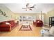 Living room with hardwood floors, a ceiling fan, and bay window at 26 Pecan Pass Run, Ocala, FL 34472