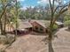 Aerial view of a ranch-style brick home with a covered carport and lush landscaping at 2685 Cr 564, Bushnell, FL 33513