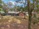 Brick home with pool and screened enclosure, nestled in a wooded backyard at 2685 Cr 564, Bushnell, FL 33513