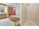 Bathroom features a shower and a large bathtub at 2685 Cr 564, Bushnell, FL 33513