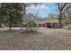 Brick home with covered carport and lush landscaping at 2685 Cr 564, Bushnell, FL 33513