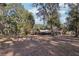 Brick home with pool and screened enclosure, surrounded by trees at 2685 Cr 564, Bushnell, FL 33513