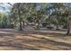 Several outbuildings are situated on a spacious lot with mature trees at 2685 Cr 564, Bushnell, FL 33513