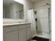 Clean bathroom with double vanity, shower, and white cabinets at 29320 Armoyan Blvd, Leesburg, FL 34748