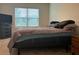 Comfortable bedroom with large window and neutral color scheme at 29320 Armoyan Blvd, Leesburg, FL 34748