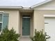 Green front door entry to a house at 29320 Armoyan Blvd, Leesburg, FL 34748