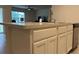 Kitchen island with granite countertop and white cabinets at 29320 Armoyan Blvd, Leesburg, FL 34748