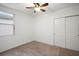 Bright bedroom with ceiling fan, window, and double door closet at 29360 Caspian St, Leesburg, FL 34748