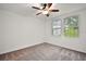 Bright bedroom with ceiling fan, neutral carpeting, and large windows at 29360 Caspian St, Leesburg, FL 34748