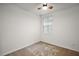 Bright bedroom with ceiling fan, neutral carpeting, and window at 29360 Caspian St, Leesburg, FL 34748