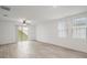 Bright living room featuring tile floors and a ceiling fan at 29360 Caspian St, Leesburg, FL 34748