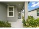 Covered side entrance with gray walls and a blue door at 29360 Caspian St, Leesburg, FL 34748