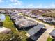 Aerial perspective of community, showcasing villas and lake at 2941 Tangerine Ct, Leesburg, FL 34748