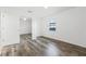 Well-lit bedroom featuring wood-look floors and mirrored closet at 2941 Tangerine Ct, Leesburg, FL 34748