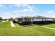 Exterior view of house with a screened lanai and pond view at 2941 Tangerine Ct, Leesburg, FL 34748