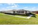 Back view of the house, showing a screened patio and landscaping at 2941 Tangerine Ct, Leesburg, FL 34748