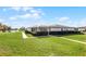 Exterior view of villa, showcasing carport and lush landscaping at 2941 Tangerine Ct, Leesburg, FL 34748