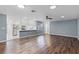 Bright living room with wood-look tile flooring and ceiling fan at 2941 Tangerine Ct, Leesburg, FL 34748