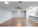 Open living room showcasing wood-look floors and a ceiling fan at 2941 Tangerine Ct, Leesburg, FL 34748