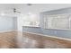 Spacious living room featuring wood-look floors and a view of the kitchen at 2941 Tangerine Ct, Leesburg, FL 34748