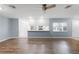 Bright living room with wood-look floors and kitchen bar at 2941 Tangerine Ct, Leesburg, FL 34748